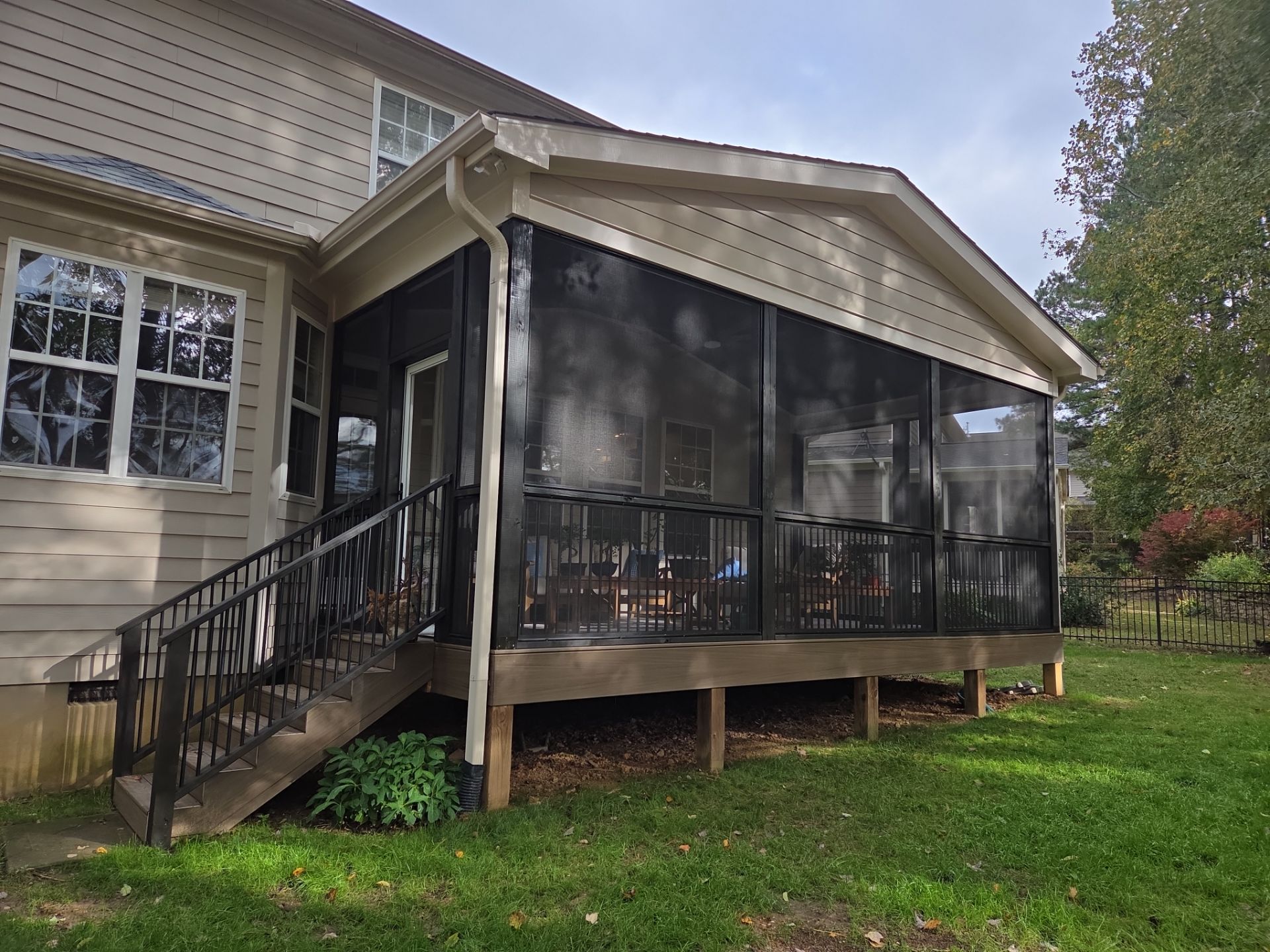 Screen room with black railings and composite stairs