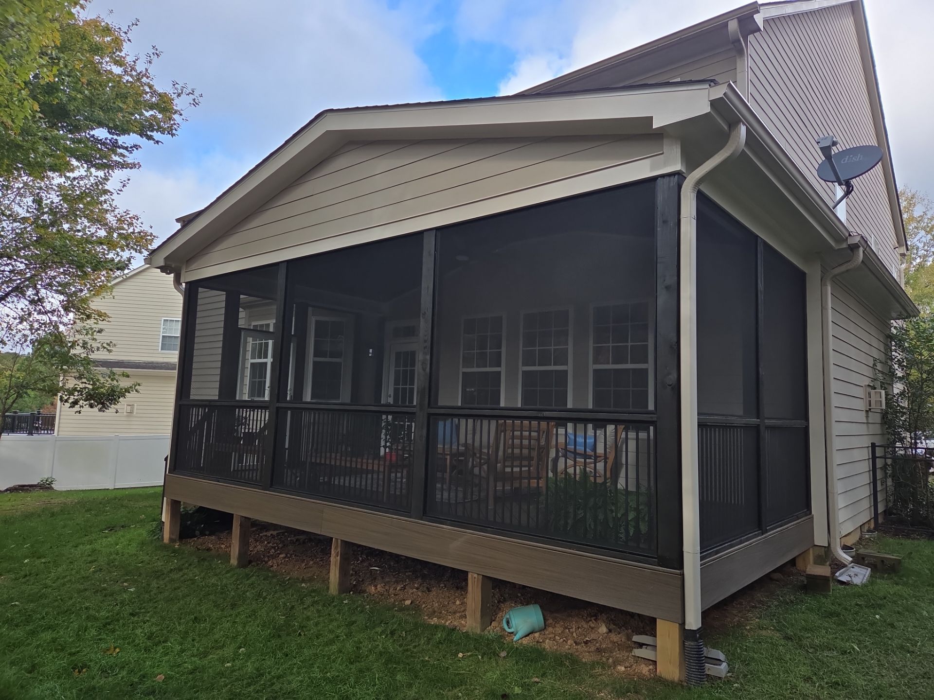 Screened-in porch on a composite deck built by Five Oaks Roofing Plus